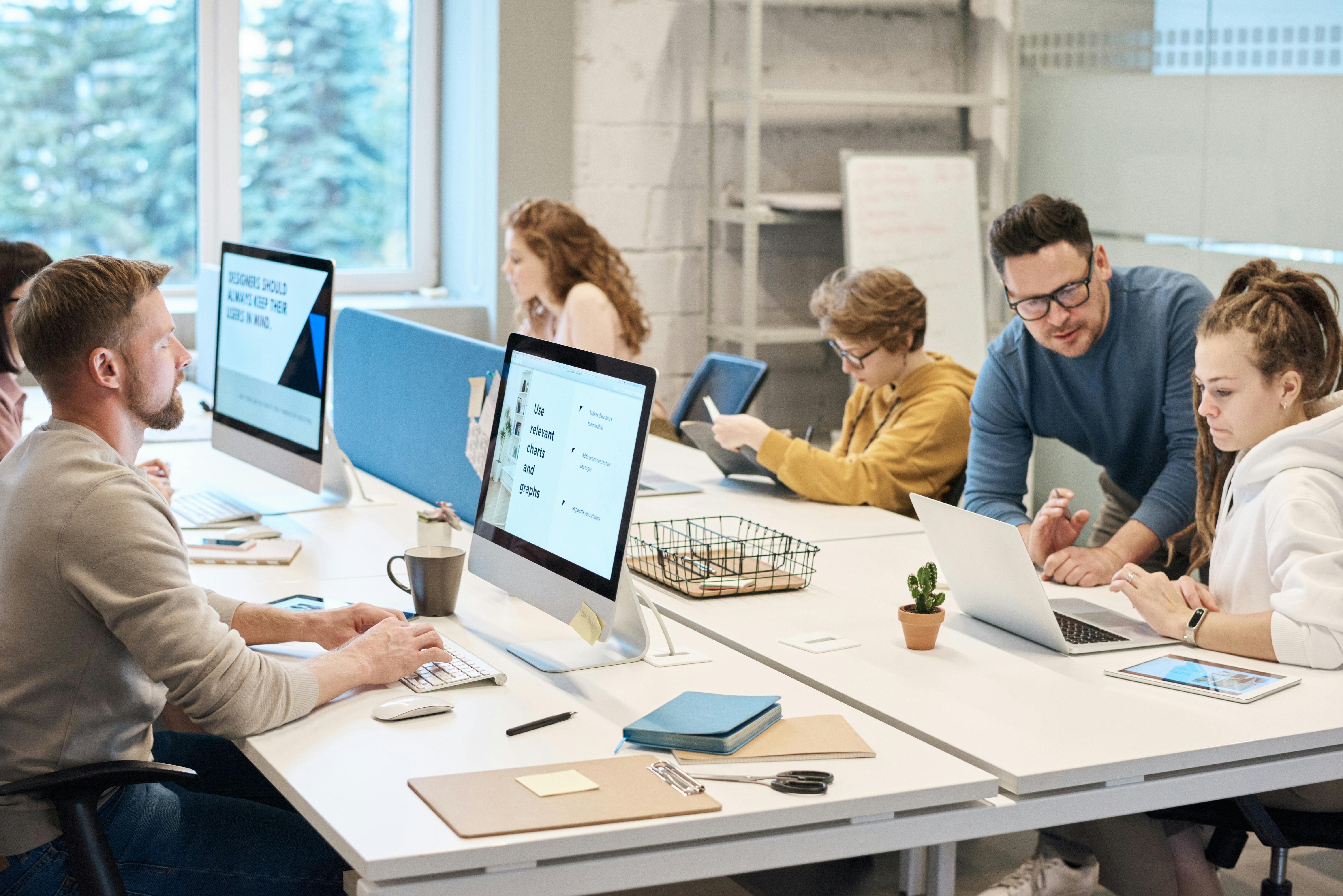 Image of people at a table in an office working